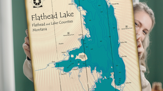 Flathead Lake Montana lake art map with topographical features and compass rose wall art wood plank sign from oldwoodsigns.com